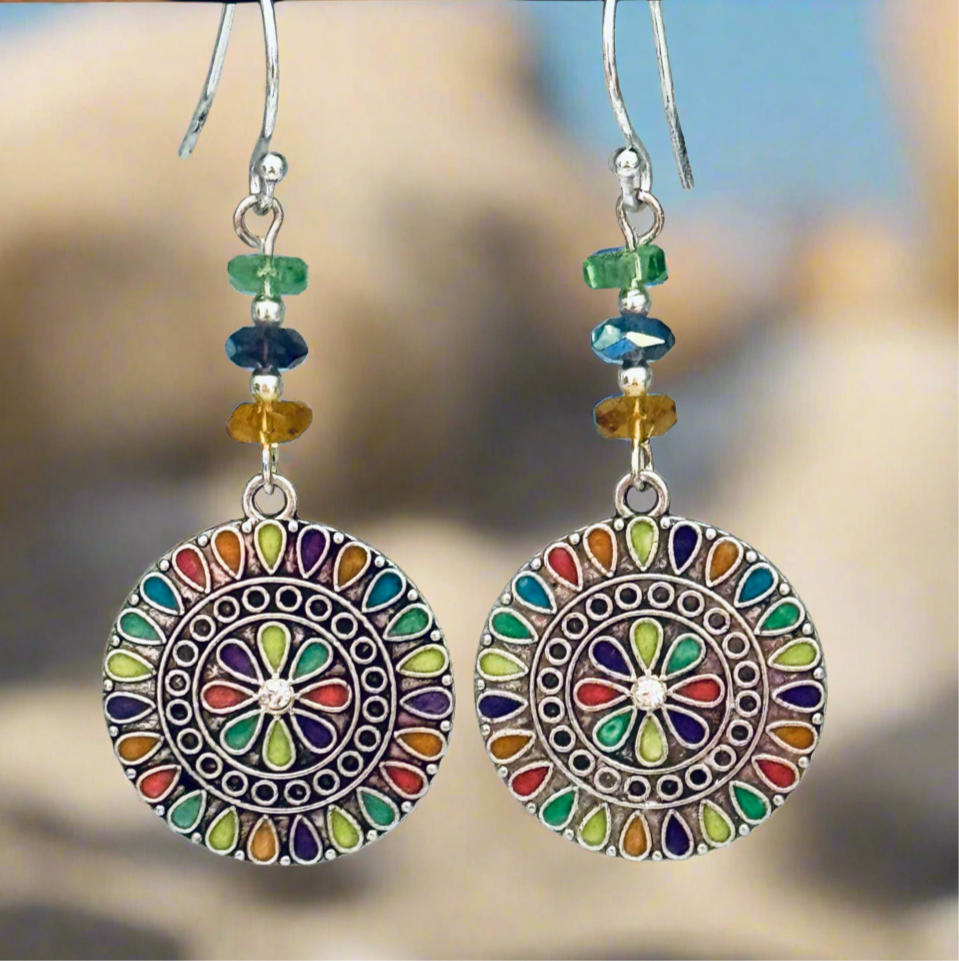 Silver Earrings adorned with crystals and multi colored charms. 2.5”