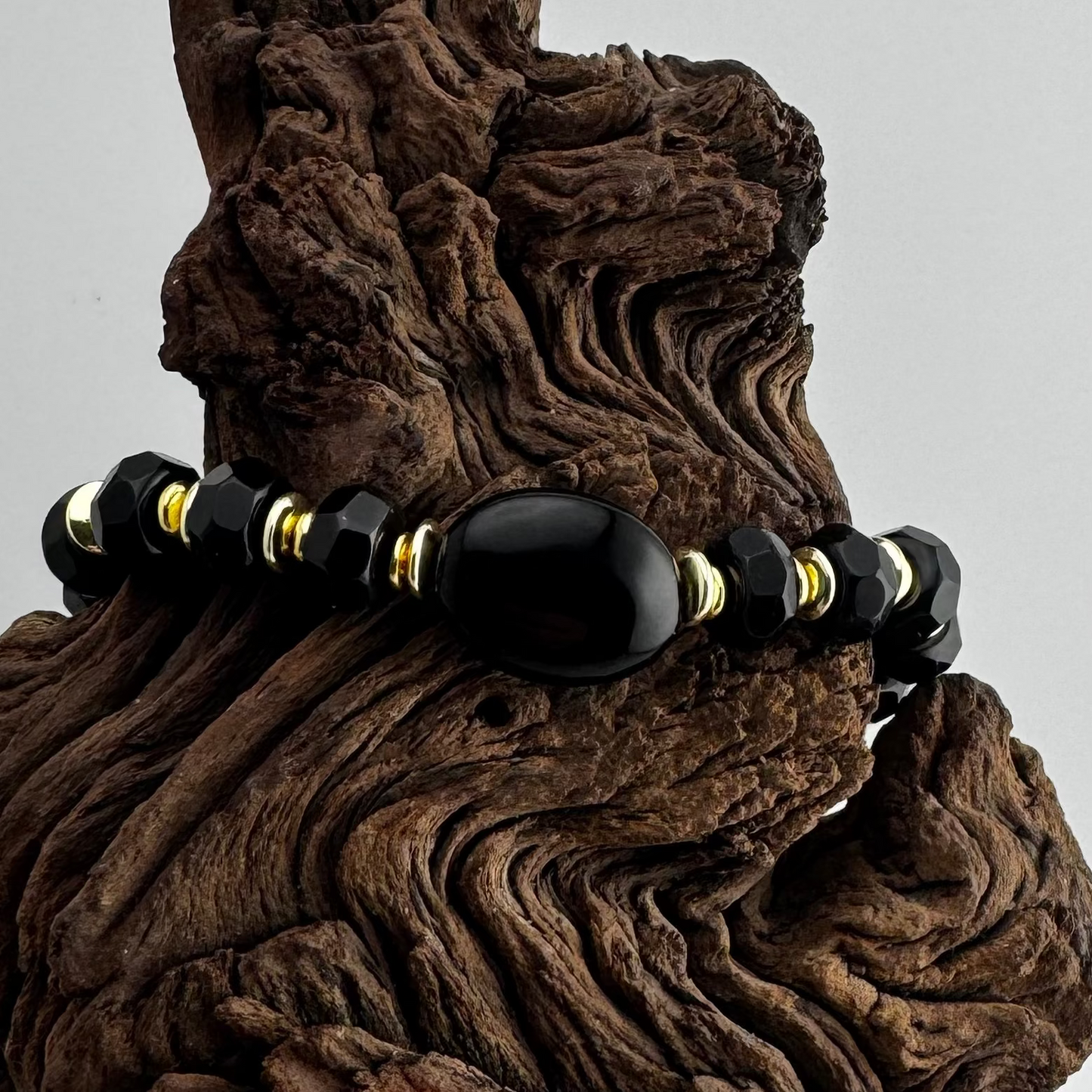 Bracelet | Onyx Faceted Rondells | 18K Gold-plated Saucer Beads | Oval Onyx Focal Bead